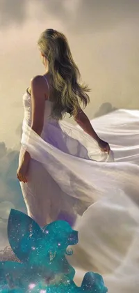 This phone live wallpaper features a woman in a white dress standing on a rock against a backdrop of clouds, waves, and butterfly wings