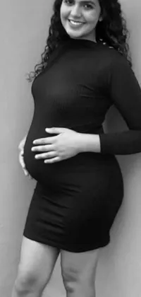 This elegant phone live wallpaper features a black and white photo of a pregnant woman overlaid with stylish and meaningful words written in script font