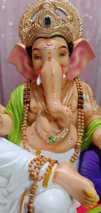 This live wallpaper features a stunning elephant statue in close-up view against a background of pink and white fabric