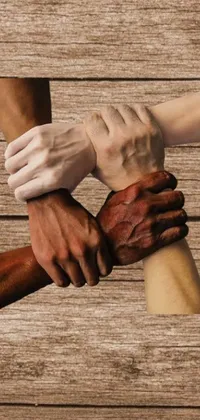 This stunning live wallpaper depicts four colored hands holding onto each other portraying a sense of strength and unity