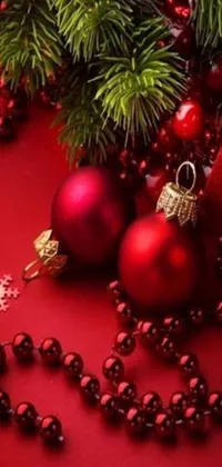 This live wallpaper for your phone features beautiful Christmas decorations in rich shades of red against a detailed red background