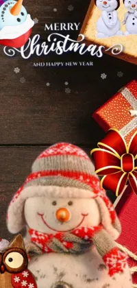 This charming phone live wallpaper features a festive snowman surrounded by presents, adding a cozy touch to your device
