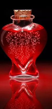 Decorate your phone's home screen with this stunning live wallpaper! Witness the breathtaking beauty of a heart-shaped glass bottle brimming with a mesmerizing red liquid that creates an ever-changing, galaxy-like effect inside