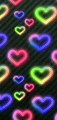 This phone wallpaper features a stunning display of multiple neon hearts on a black background