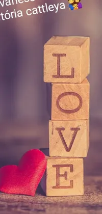 This lovely live wallpaper for mobile phones features wooden blocks and a red heart