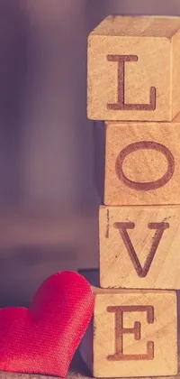 This wooden block love live wallpaper features a heartfelt design with the word "love" engraved on a rustic wooden block