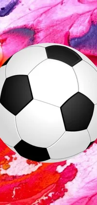 This live phone wallpaper shows a soccer ball on a colorful surface with flowers in the background
