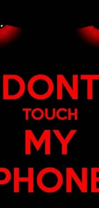 This live phone wallpaper is a striking poster that demands attention, featuring the words &quot;Don&#39;t Touch My Phone&quot; in bold white font set against a dark background that creates a dramatic contrast