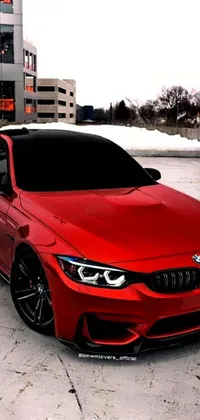 This live phone wallpaper features a vibrant red car parked in a parking lot adjacent to a modern office building