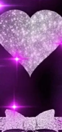 Looking for a captivating phone wallpaper to add a touch of romance and magic to your screen? Look no further than this heart and bow design on a stunning purple background! Featuring glittering, shimmering dust in the air and a bright shining star, this design is sure to make your phone stand out