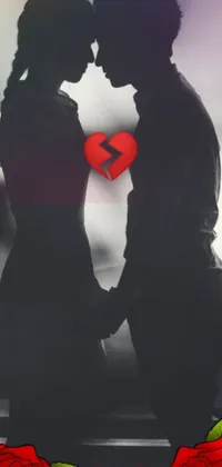 This phone live wallpaper features a touching image of a couple standing next to each other in front of a heart