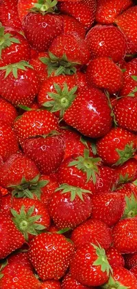 This live wallpaper features a stunning image of a pile of red strawberries