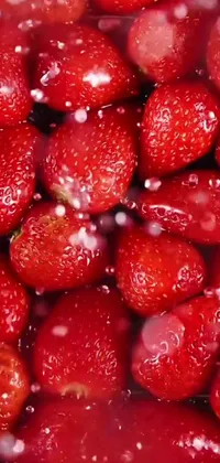 This phone live wallpaper showcases a close-up image of ripe, mouthwatering strawberries