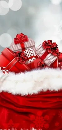 This phone live wallpaper showcases a vivid red bag bursting with presents and adorned with a colorful picture at its center