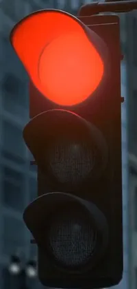 This mobile wallpaper features a close-up view of a traffic light illuminated with a mangeta smoke red light against a dark blue sky