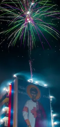 This phone live wallpaper depicts a spectacular fireworks display against a tall building