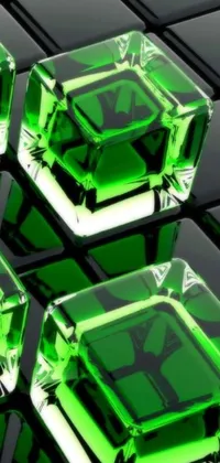 This phone live wallpaper features three green crystal cubes atop a black keyboard in an abstract design known as crystal cubism