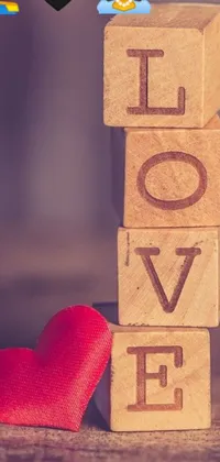 Get ready to add a romantic touch to your phone with this charming live wallpaper! Featuring wooden blocks and a red heart in between, symbolizing a deep connection between two people, and a beautiful picture of romanticism by Alexander Brook, this wallpaper will make your phone feel more personal and stylish