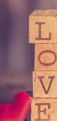This love-themed wallpaper features a wooden block with the word "love" and a red heart