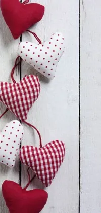 Looking for a charming live wallpaper for your phone? Check out this red and white hearts string wallpaper! Crafted from a checkered fabric, these cheerful decorations will bring a cozy, homey feel to your screen