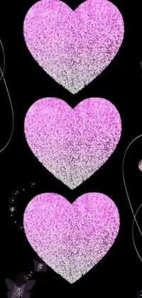 This phone live wallpaper showcases a captivating design by Florianne Becker, with a dark black background dotted with pink sparkling hearts