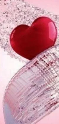 This phone live wallpaper captures the essence of love with a stunning red heart floating in soothing water