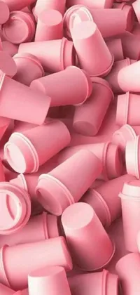 This live wallpaper showcases a delightful stack of pink cups in different sizes arranged on top of each other, creating a playful display of varying pastel shades