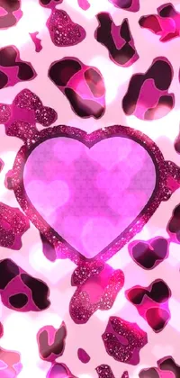This phone live wallpaper boasts a charming pink heart with black and pink satellites, set on a lovely purple background