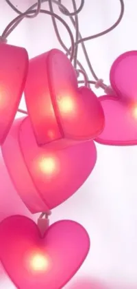 Get your phone screen looking enchanting with our Pink Heart Shaped Lights hanging phone live wallpaper! Adorned with a bunch of lovely heart-shaped lights in delicate pink, these lights sway in gentle breeze creating a soft and romantic ambiance