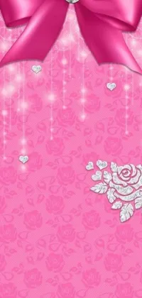 This phone live wallpaper features a stunning pink background adorned with a bow, flowers, pearls, and crystals