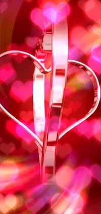 This phone live wallpaper features a heart-shaped pair of scissors illuminated with vibrant pink neon lights in a 3D animated effect