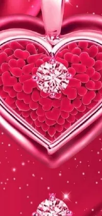 This phone live wallpaper features a heart-shaped diamond necklace on a vibrant red background, enhanced by delicate pink petals and glitter effects