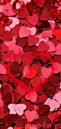 This phone live wallpaper features a romantic image of red and pink heart-shaped confetti on a vibrant red background