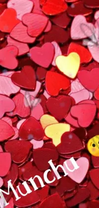 Experience a vibrant and alluring live wallpaper featuring a plethora of heart-shaped confetti in shades of red and yellow atop a table