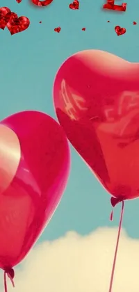 This live wallpaper for your phone displays two red heart-shaped balloons floating in the sky on a sunny day