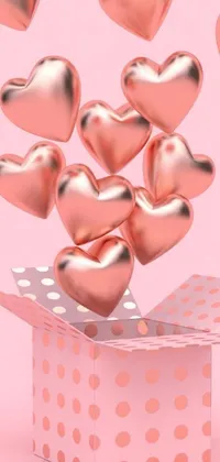 This live wallpaper for your phone features an adorable box with colorful hearts soaring outwards, set against a lovely rose gold heart background