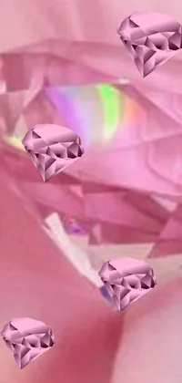 This phone live wallpaper features a stunning pink diamond held by a hand, surrounded by a holographic glow