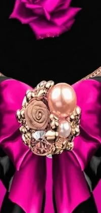 This phone live wallpaper depicts a close-up of a stunning necklace with a beautiful rose pendant at its center