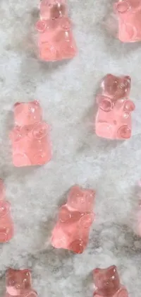 Get ready to indulge in your sweet tooth with this delightful phone live wallpaper of a pink gummy bear-laden tabletop