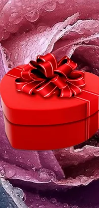 This mesmerizing phone live wallpaper features a red heart-shaped box and a rose artfully designed with a blend of red and purple colors