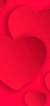 Get this visually appealing live wallpaper for your phone! Featuring a bright red background with three intricate heart designs cut out of paper, this wallpaper will add tons of character to your device's screen