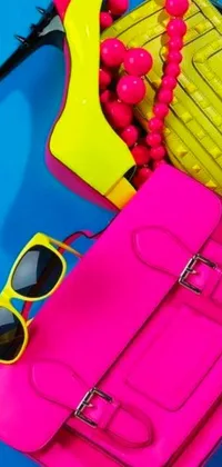 Experience the vibrance and liveliness of this phone live wallpaper that features a stunning design with pink and yellow purses and sunglasses on a bright blue surface