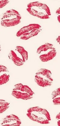 This lively phone wallpaper features a repeating pattern of red lipstick kisses on a light ecru background