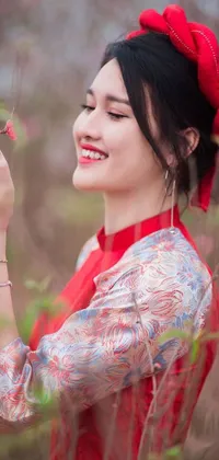 This phone live wallpaper showcases a woman wearing an authentic red dress with a charming smile and red lipstick