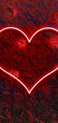 This live wallpaper features a vibrant image of a glowing red heart set on a background of green grass