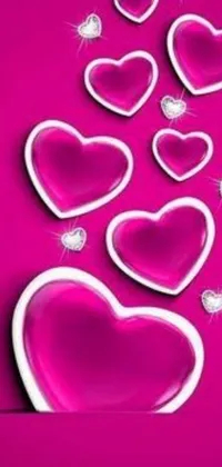 This stunning phone live wallpaper features playful pink hearts set against a vibrant pink backdrop