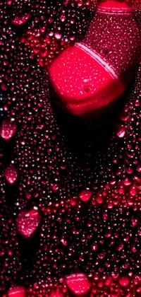 This live phone wallpaper showcases a captivating close-up of water droplets on a phone screen against a bold black backdrop, accentuated with deep red hues