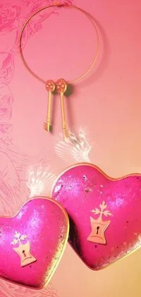 This romantic live wallpaper features two delightful pink hearts resting on a wooden table, accompanied by a golden key