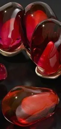 This stunning phone live wallpaper features a group of red glass pieces arranged in an elegant and exuberant form
