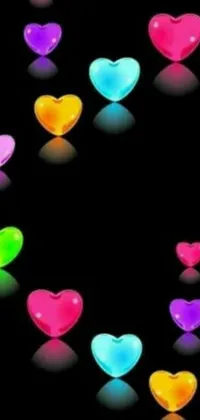 This live phone wallpaper features multicolored hearts against a black backdrop